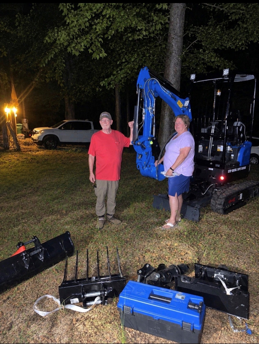 Robert W. and his wife receiving their blue Rippa R18 mini excavator from Ironcrest Equipment in Tuscaloosa, Alabama